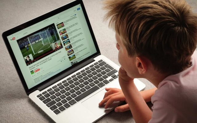 A Child watching Youtube videos on a laptop computer