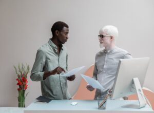 multiracial coworkers with papers in office