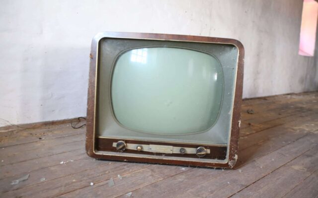 vintage brown crt tv on parquet wood flooring