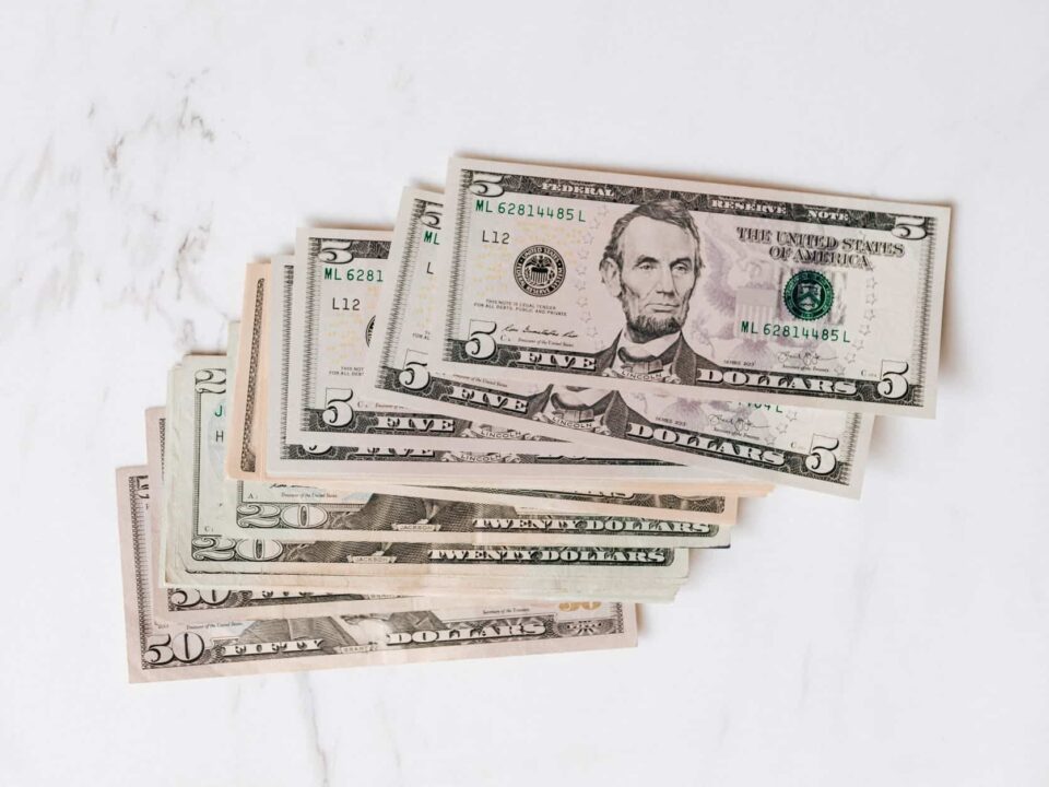 stack of different dollar banknotes on marble table