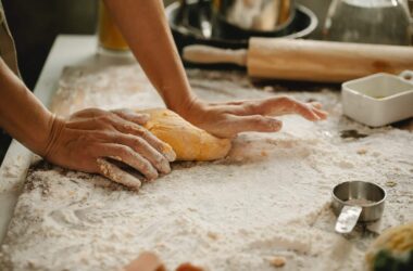 woman making pastry on table with flour