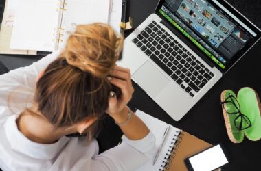 woman sitting in front of macbook